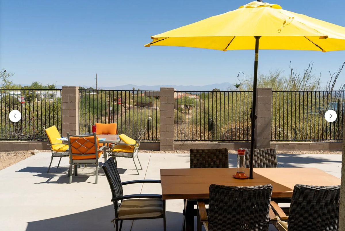 House One outdoor patio with yellow umbrella and mountain view
